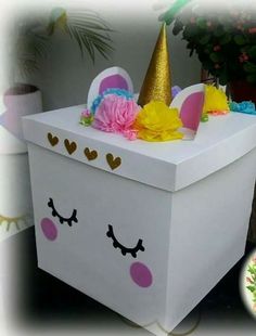 a white box with pink and yellow decorations on it