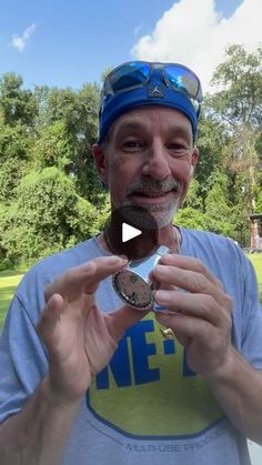 a man holding up a medal in front of his face