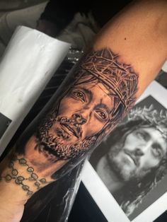 a man with a crown on his head tattoo