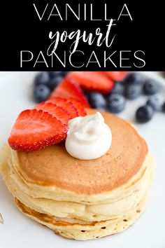 a stack of pancakes with whipped cream and strawberries on top