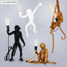 three monkey figurines holding light bulbs in their hands, one with a monkey on it's back