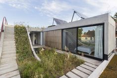 the house is made out of concrete and has stairs leading up to it's roof