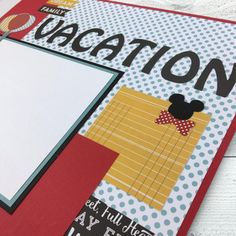 a close up of a scrapbook with a mickey mouse theme on the front cover