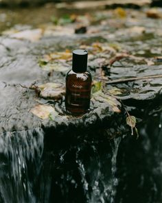 a bottle of shampoo sitting on top of a waterfall