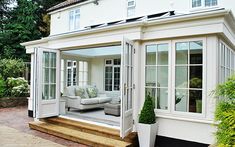 a white house with an open patio and sitting area