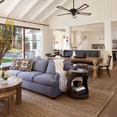 a living room filled with furniture and a ceiling fan