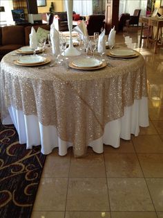 an image of a table set up for a wedding party with gold sequins on it