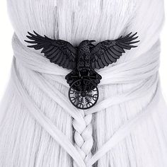 the back of a woman's white dress with an eagle brooch on it