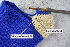 the crochet is being worked on by someone who has knitted it in blue and white