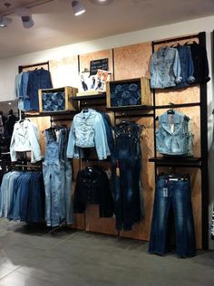 a clothing store with jeans and jackets on display