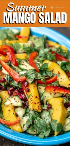 a blue plate topped with mango salad and garnished with cilantro peppers