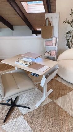 a chair and table in a room with wood beams on the ceiling, white walls