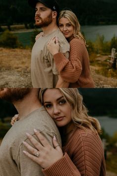 a man and woman hugging each other in front of a lake with mountains behind them