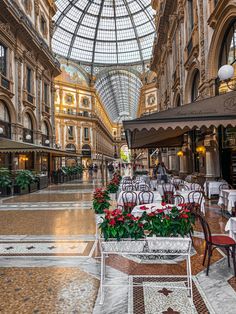 the interior of a shopping mall with tables and chairs set up in front of them