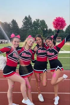 the cheerleaders are posing for a photo on the track with their pom poms