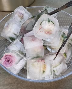 ice cubes with flowers on them in a bowl