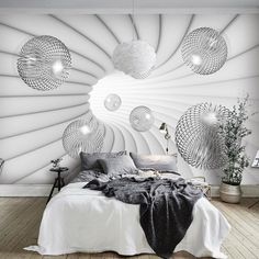 a bed room with a neatly made bed and lots of lights on the wall above it