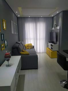 a living room with grey walls and yellow accents is featured on the instagram page