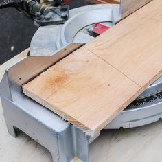 a person using a circular saw to cut wood