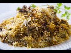 a white plate topped with rice and meat covered in grated parmesan cheese