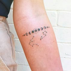 a person with a tattoo on their arm that has numbers and stars in it,