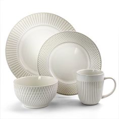 a white dinner set with matching cups and saucers