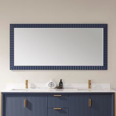 a bathroom vanity with two sinks and a large mirror on the wall above it,