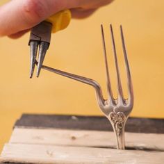 a person holding a fork with two forks attached to it