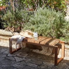 a wooden bench sitting in the middle of a garden