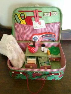 an open suitcase filled with lots of crafting supplies