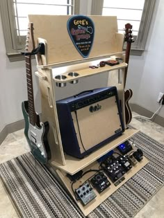 a guitar amplifier sitting on top of a table next to other musical instruments and amps