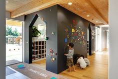 two children are playing with magnets on the wall