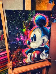 a mickey mouse painting sitting on an easel