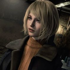 a woman with blonde hair wearing a brown sweater and black jacket in a dark room