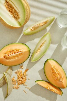 melon slices and seeds on a white surface