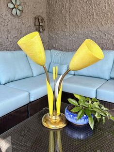 a blue couch and table with yellow flowers on it