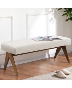 a white bench sitting on top of a hard wood floor