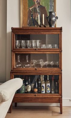 a wooden shelf filled with glasses and bottles