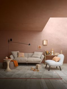 a living room with pink walls and furniture