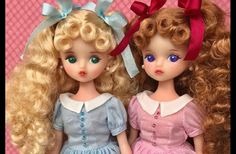 two dolls are sitting next to each other