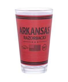 a shot glass with the words arkansas razorbacks printed on it and an american flag