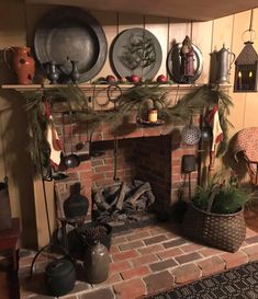 a fire place with pots and pans on the mantle