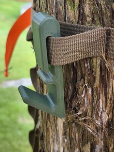 an umbrella hook is attached to a tree