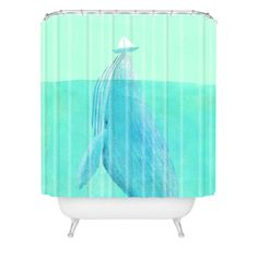 a shower curtain with a blue whale in the ocean