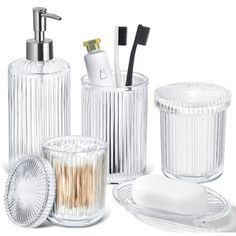 an assortment of bathroom accessories including toothbrushes and soap dispenser