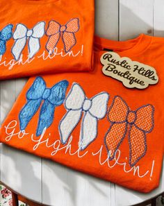 two orange tshirts with bows on them