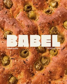 a close up of a pizza with olives on it and the words babel above it