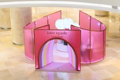 the entrance to kate spade's new york store is pink with gold trimmings