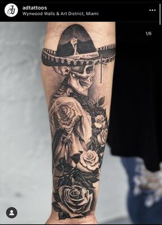 a person with a tattoo on their arm wearing a sombrero and holding flowers