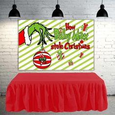 a red table with a green and white sign on it that says how the grin stole christmas